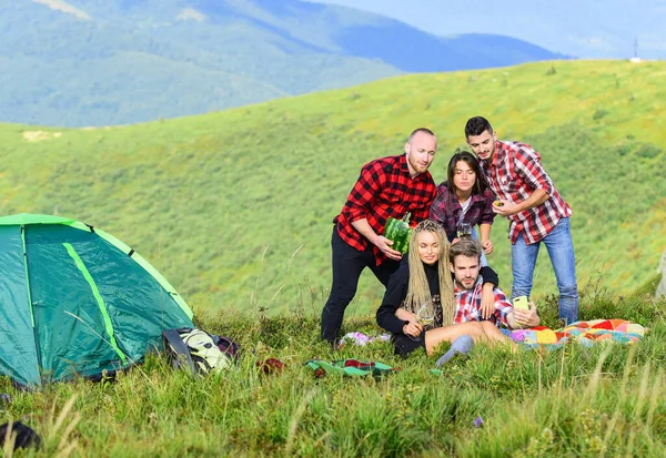 People eating food. Hike picnic. Friends enjoy vacation. Pleasant hike picnic. Camping concept. Youth having fun picnic in highlands. Summer adventures. Group friends relaxing picnic in mountains.