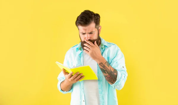 Serious Hipster Guy Reading Notebook Yellow Background Curiosity — Foto Stock