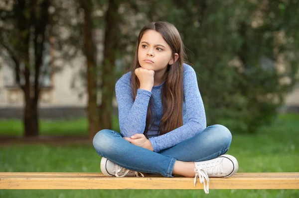 Thinking Teenage Girl Thinking While Sitting Legs Crossed Bench Outdoors — Foto de Stock