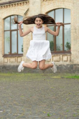 glad funny teen girl. jumping girl having fun. teenager girl jump outdoor.