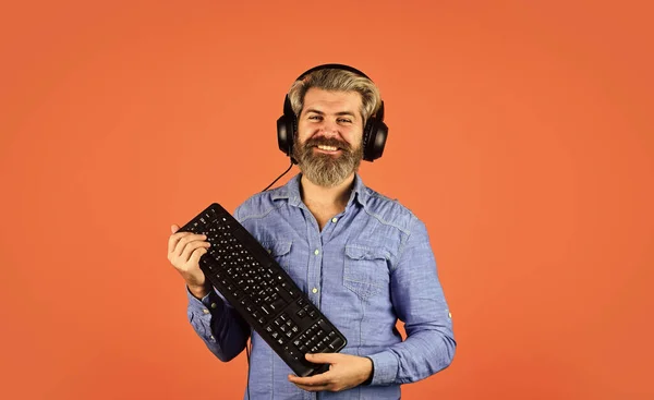 Shop gadgets. Hipster gamer headphones and keyboard. Gaming addiction. Graphics settings pushed to limit. Play computer games. Superior performance. Online gaming. Modern leisure. Run any modern game.