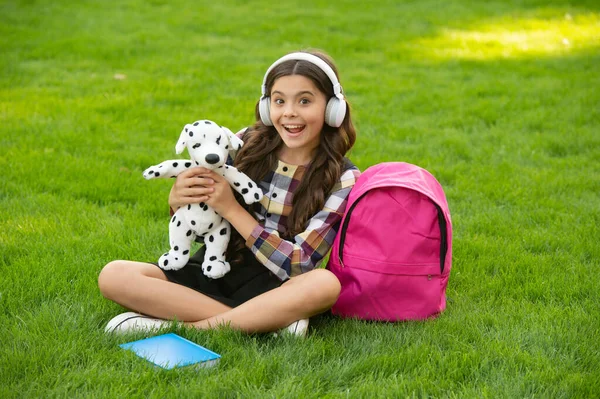 Surprised Teenage Girl Listening Music Holding Dog Toy Grass School — Zdjęcie stockowe