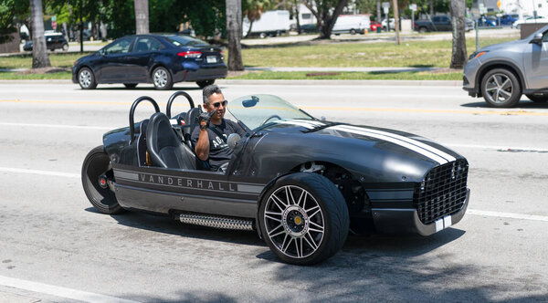 Miami Beach, Florida USA - April 15, 2021: vanderhall tree wheeled venice roadster tricycle, corner view.