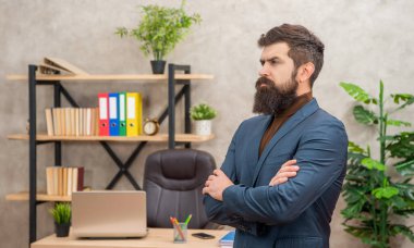 serious unshaven boss wear suit in the office with copy space, charisma.