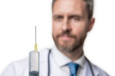 syringe in hands of doctor. syringe for medical injection. selective focus of injecting syringe.