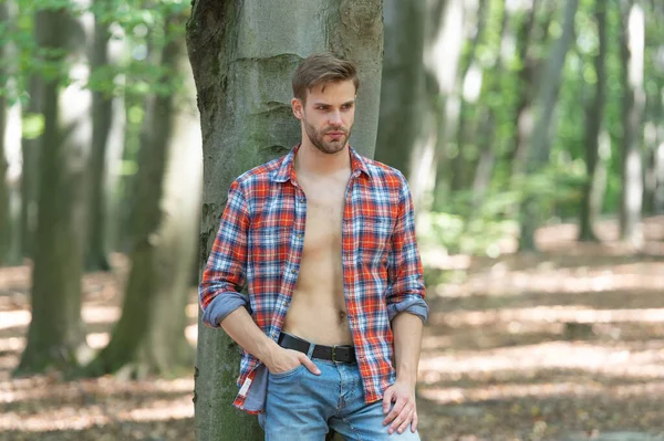 Unshaven Lumbersexual Guy Unbuttoned Lumberjack Shirt Standing Tree Forest Background — Stockfoto