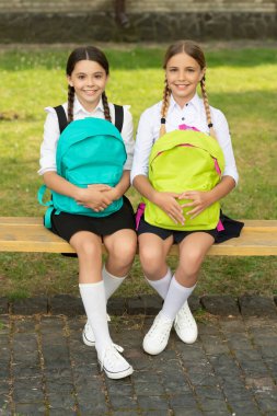 back to school. two cheerful teen children after school outdoor. friendship of school girls.