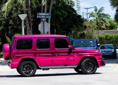 Miami Beach, Florida USA - April 15, 2021: pink metallic mercedes benz g63 AMG by impressive wrap, side view.