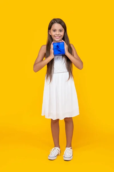 Cheerful Teen Kid Hold Present Box Yellow Background — Zdjęcie stockowe