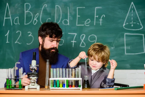 Genius kid. Joys and challenges raising gifted child. Teacher bearded scientist man child test tubes. Chemical experiment. Genius child private lesson. Knowledge day. Genius minds. Special and unique.