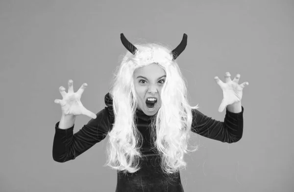 creepy girl wear devil horns having long white hair wig creating halloween mood, halloween all saints.