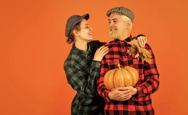 Work at fields. Harvest festival. Farmers market. Autumn mood. Fall season. Autumn leaves. Farmer family concept. Autumn harvesting works. Couple in love checkered rustic outfit. Retro style.