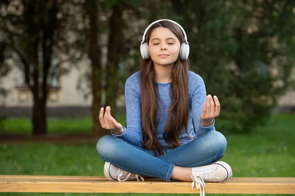Meditating Teen Girl Listening Music Headphones Meditating Bench Outdoors Meditating — Foto de Stock