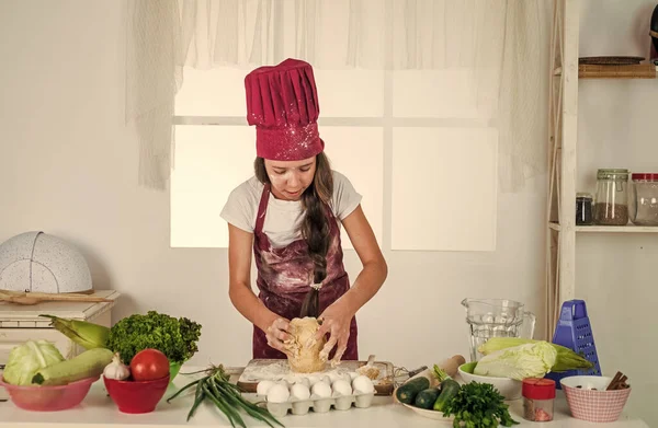 girl kid in chef apron and hat cooking, cuisine.