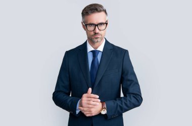 mature ceo wear businesslike suit on grey background.