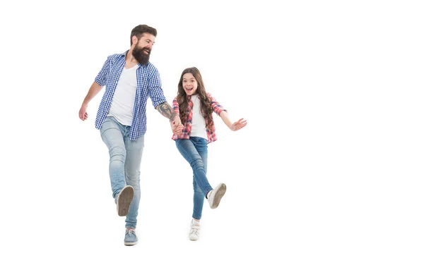 Unstoppable. Energetic daughter and father walk holding hands. Happy family in energetic mood. Photo shoot in studio. Staying energetic and positive. Enjoy fun. Feel pleasure. Energetic and active.