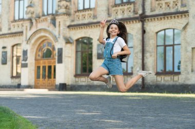 positive teen kid jump. energetic teen girl jump outdoor. free teen child jump.