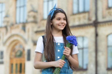 smiling girl with spring flowers on womens day.