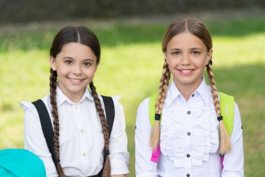 schoolgirl portrait. two happy teen children schoolgirls outdoor. friendship of schoolgirls.