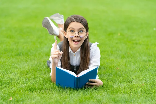 Happy Teenage Girl Book Got Idea Keeping Finger Raised Lying — Photo