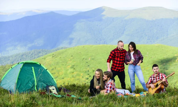 Summer adventures. Group friends relaxing picnic in mountains. Hike picnic. Friends enjoy vacation. Pleasant hike picnic. People eating food. Camping concept. Youth having fun picnic in highlands.