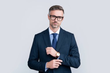 mature boss in formal suit with eyeglasses and wristwatch.