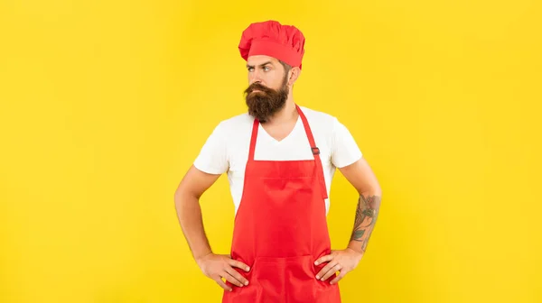 Confident Man Red Toque Apron Looking Aside Arms Akimbo Yellow — Stockfoto