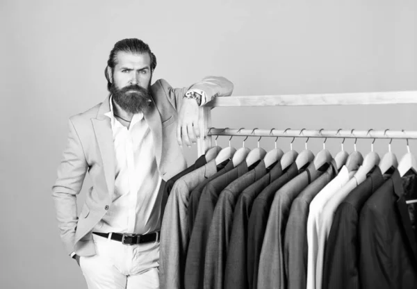 elegant businessman choose elegant apparel for formal event. atelier or wardrobe. gentleman with groomed hair. male beauty and fashion. showroom concept. bearded man in formalwear. Get the Aesthetic.