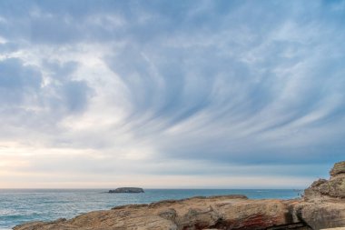 cloudy sky with beach cliff and ocean nature.