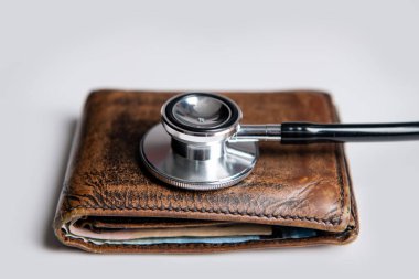 closeup of stethoscope and wallet as symbol of medical insurance. life planning and medical insurance. medical insurance concept.