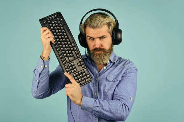 Run any modern game. Gaming PC build guide. Graphics settings pushed to limit. Gaming addiction. Online gaming. Modern leisure. Play computer games. Man bearded hipster gamer headphones and keyboard.