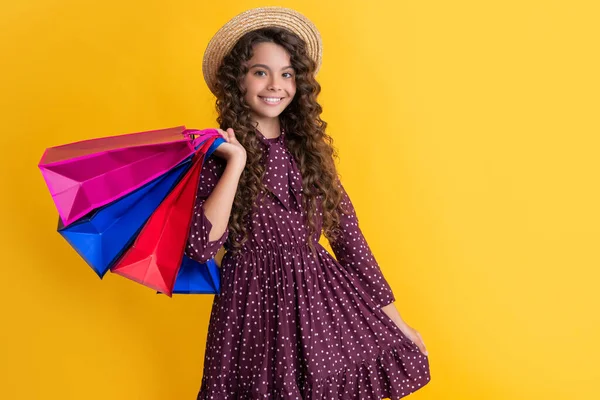 Positive Child Curly Hair Hold Shopping Bags Yellow Background — Stockfoto