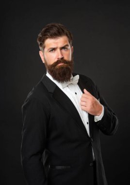 bearded businessman in tuxedo on black background, boss.