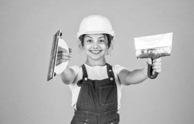 Sanırım sana yardım edebilirim. Kasklı çocuk inşaat alanında. Alet spatulası olan genç bir sıva ustası. Çocuk tamir işiyle uğraşıyor. Atölyede yenileme konsepti. Meşgul profesyonel marangoz malayla.