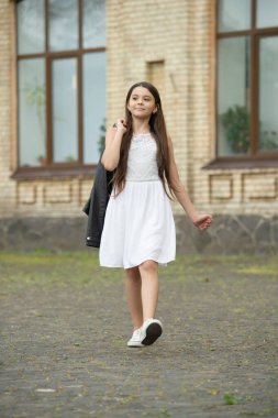 positive pretty teen girl. adorable girl fashion model. teenager girl walking outdoor.