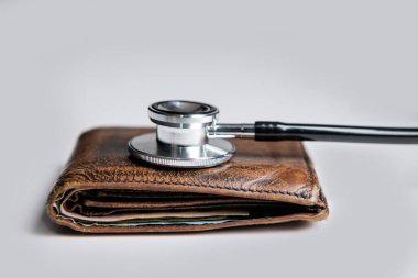 expensive medicine concept. stethoscope and wallet as symbol of expensive medicine. healthcare and medicine are expensive. closeup.