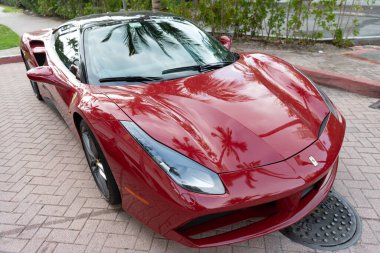 Miami Beach, Florida USA - April 18, 2021: red Ferrari 488 GTB, corner view high angle.