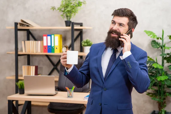 Happy Businessman Suit Talking Mobile Phone While Drinking Tea Office — kuvapankkivalokuva