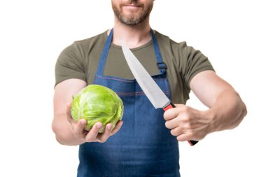 cropped view of man in apron cut cabbage and knife isolated on white.