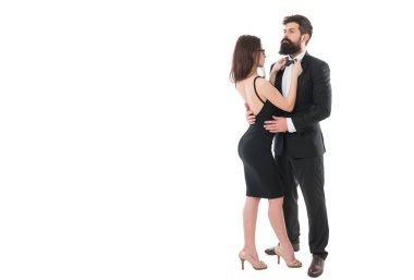 Being together. formal couple grooming for formal event. woman fix bow at males tuxedo. brutal man embrace his lady. couple in love. business meeting and partnership. love and romance.