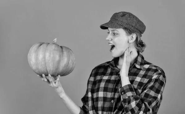 Family farm. Woman rustic farmer presenting pumpkin. Farming and agriculture. Agriculture concept. Farmer carry big pumpkin. Cooking recipe. Harvest in garden. Homegrown pumpkin. Organic farming.