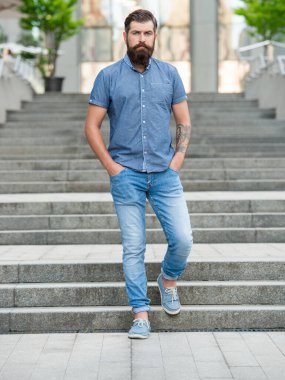 bearded man walk downstairs. full length of man with beard. hipster man outdoor.