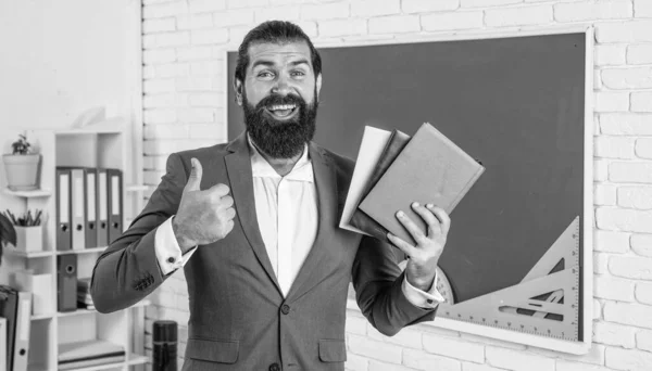 best literature. back to school. formal education. knowledge day. mature bearded teacher at lesson. brutal man work in classroom with blackboard. prepare for exam. college lecturer on lesson.