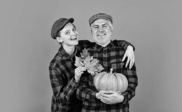 Farm products. farmer harvesting in countryside. fall seasonal concept. Autumn family harvest. Happy Thanksgiving day. Happy halloween. retro couple hold pumpkin. man and woman with maple leaf.