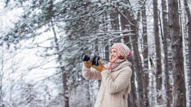 Traveling concept. Capturing winter. Take stunning winter photos. Winter hobby. Woman photographer professional camera. Inspiration create something special. Girl with vintage camera in snowy nature.