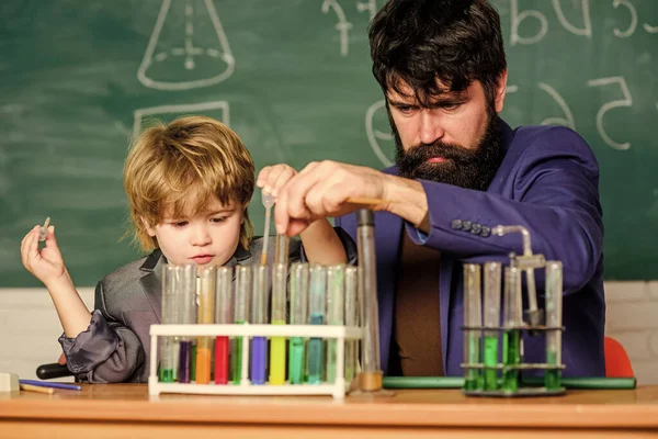 Experience and innovation in a single touch. biology and chemistry education. Back to school. Educational concept. teacher man with little boy. School education. father and son at school.