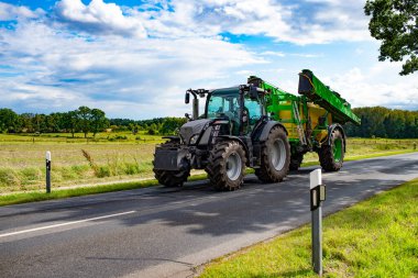 heavy machinery of tractor loader on rural road.