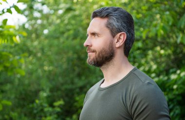 profile view of bearded man in shirt. caucasian man with beard. mature man outdoor. copy space.