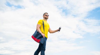 Man traveller travelling on vacation sky background, copy space.