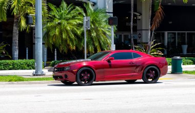Miami Beach, Florida USA - April 15, 2021: red Chevrolet Camaro car, side view.